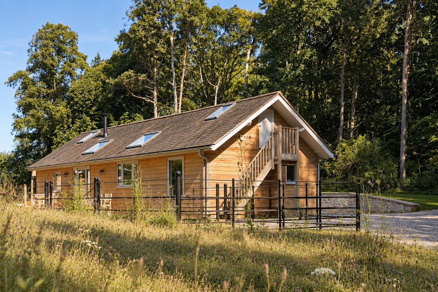The actual Old Workshop exterior, showing the timber building, roof skylights and external stair